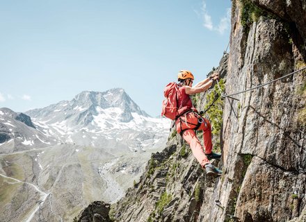 Kletterin bei Querung im Klettersteig