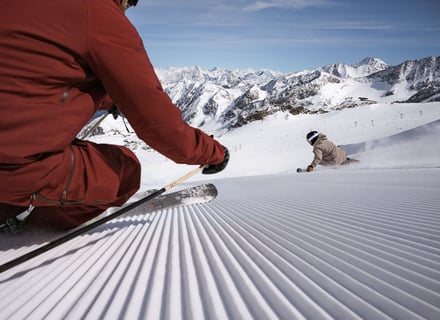 Roter Skifahrer und beige Skifahrerin aus der Point-of-View Perspektive am Stubaier Gletscher